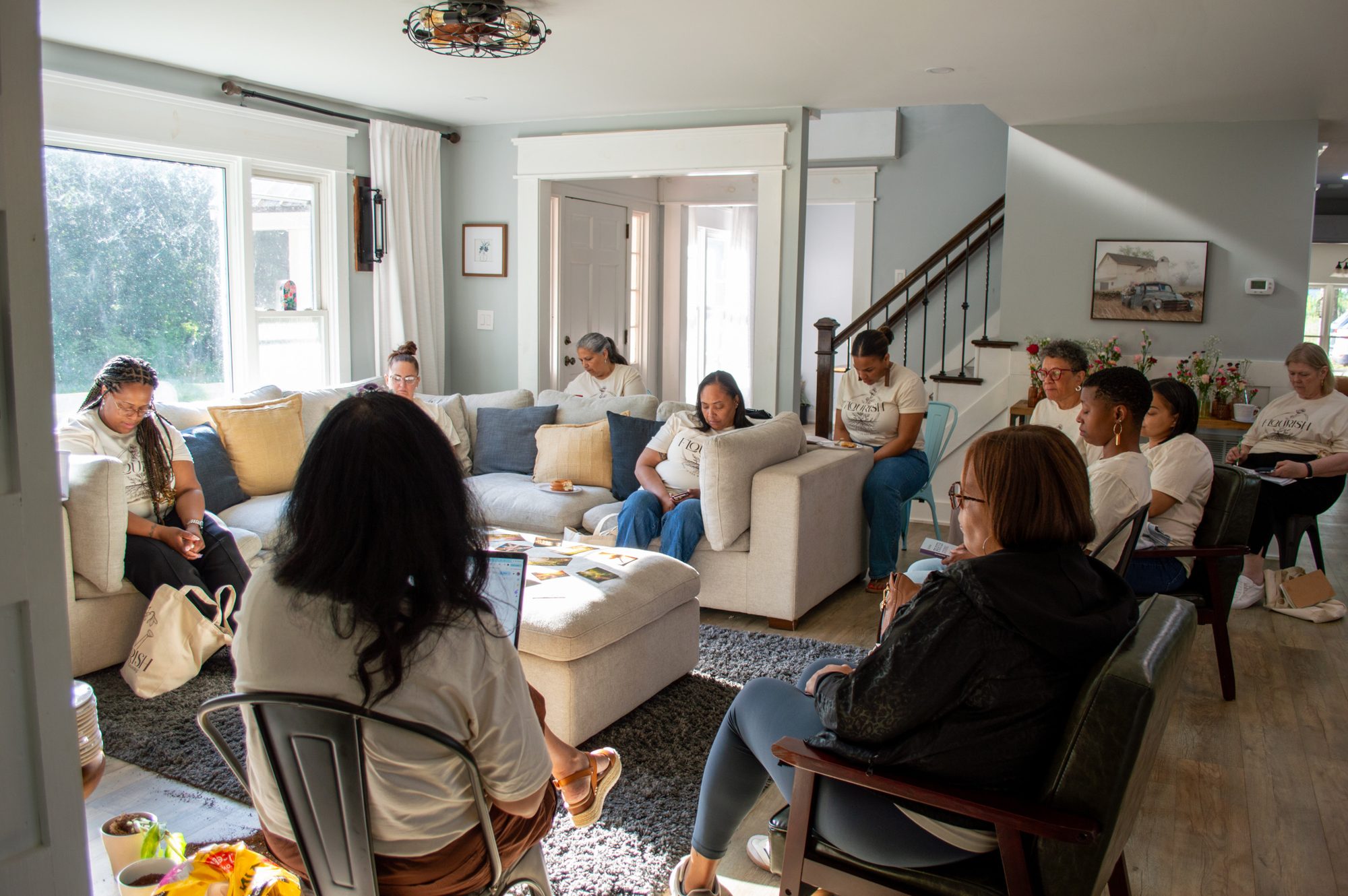Women in quiet reflection during a session in the living room