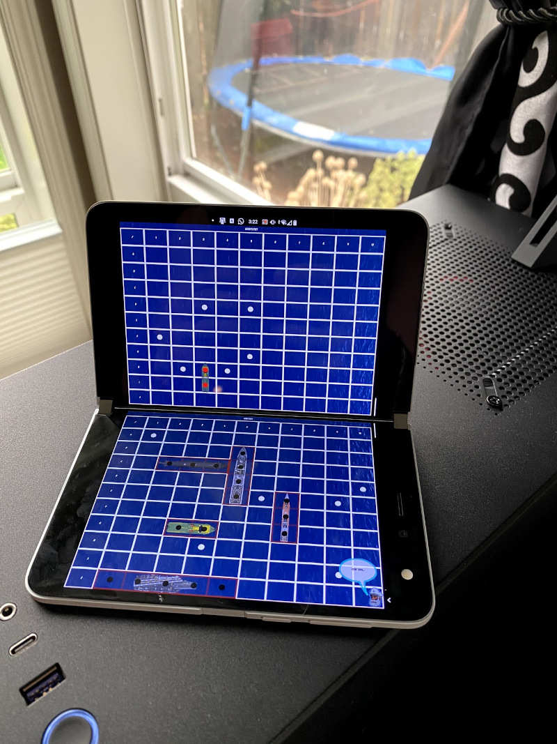 picture of a Surface Duo running Battleship demo game