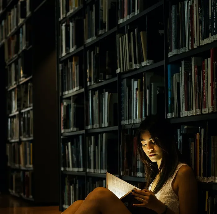 girl reading book in library