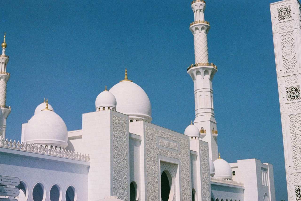 Sheikh Zayed Grand Mosque white domes and minaret, Abu Dhabi, day, solid blue sky