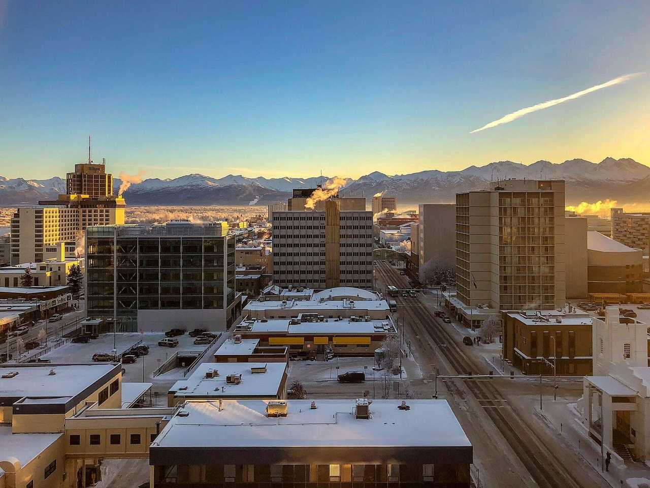 Anchorage skyline and Chugach Mountains, winter day, blue sky