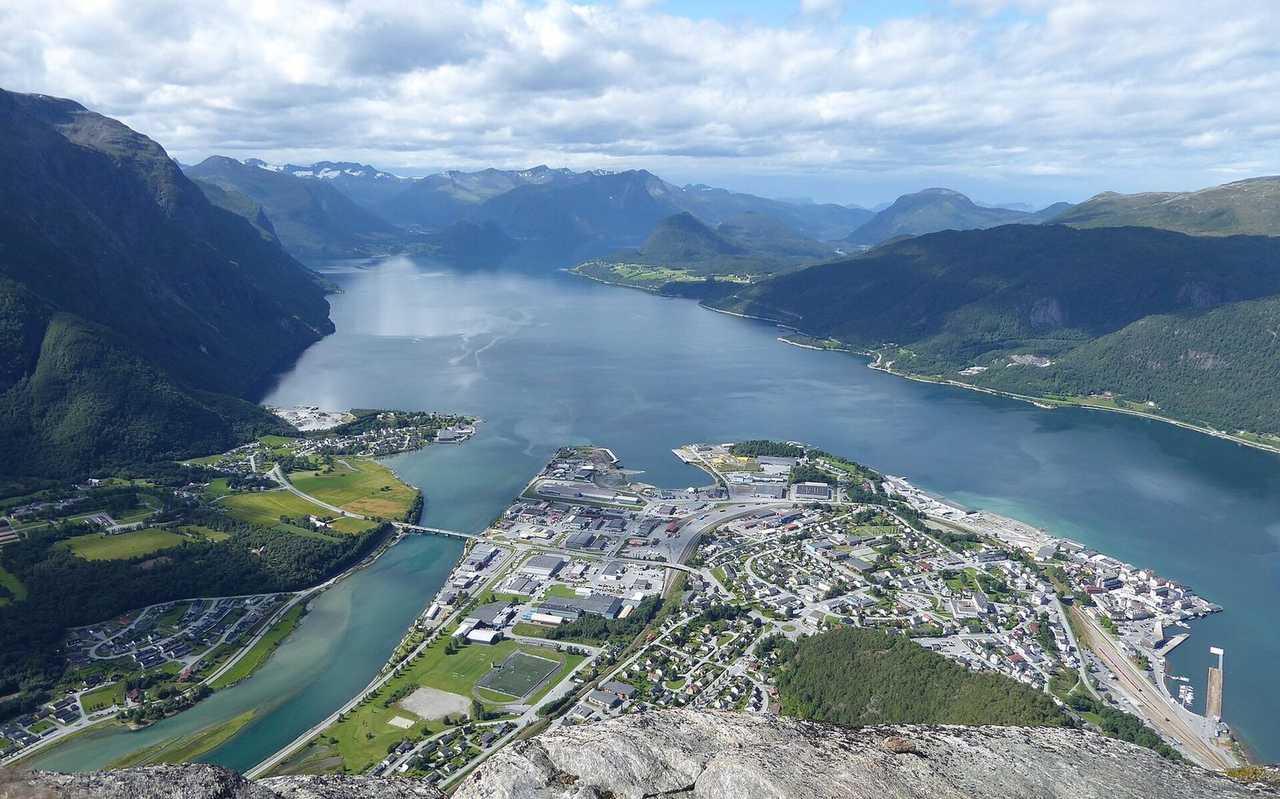 Aandalsnes town in the fjord from a nearby mountain, day, blue sky