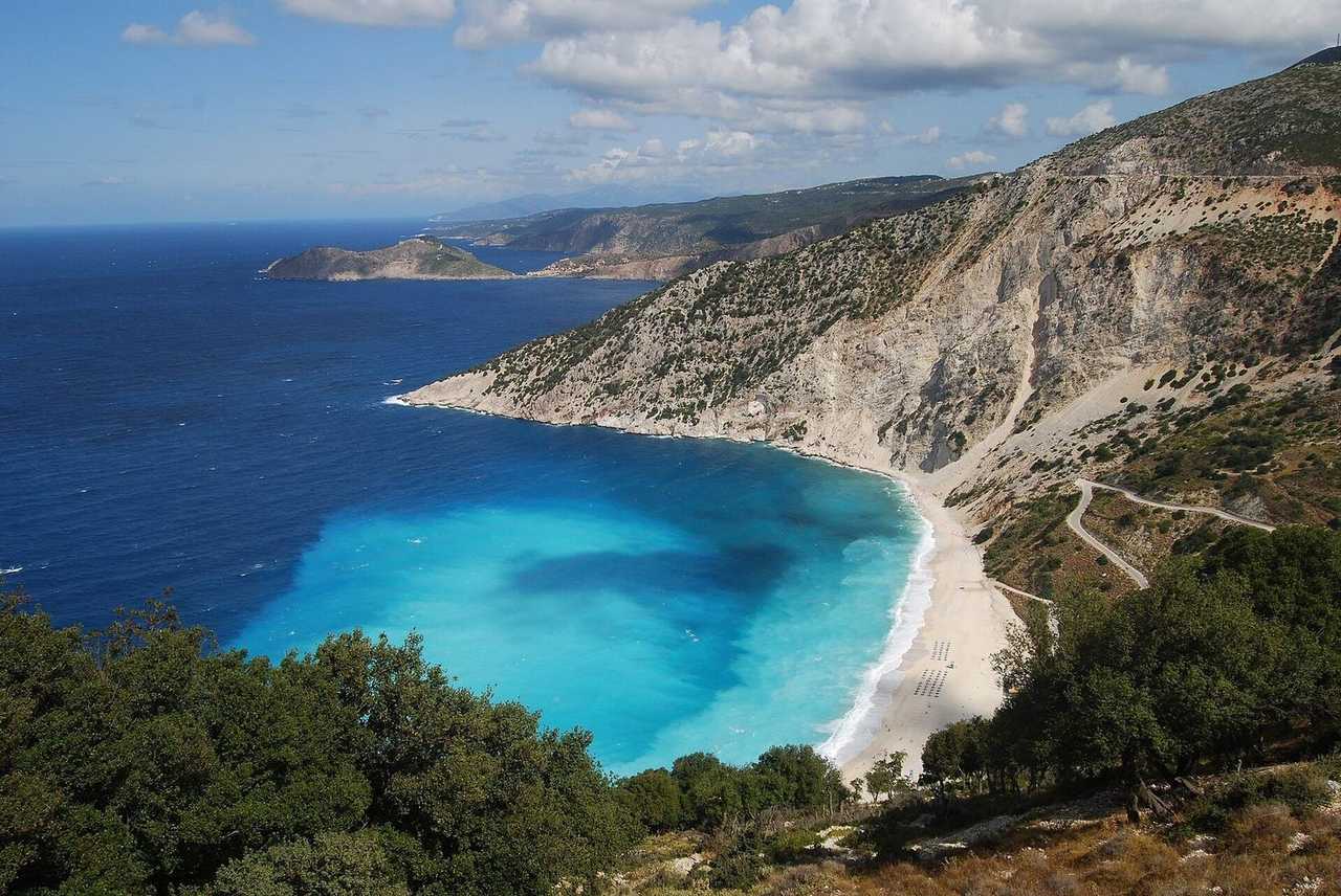 Myrtos Beach crescent and turquoise bay, Kefalonia (Argostoli), day, blue sky with light clouds