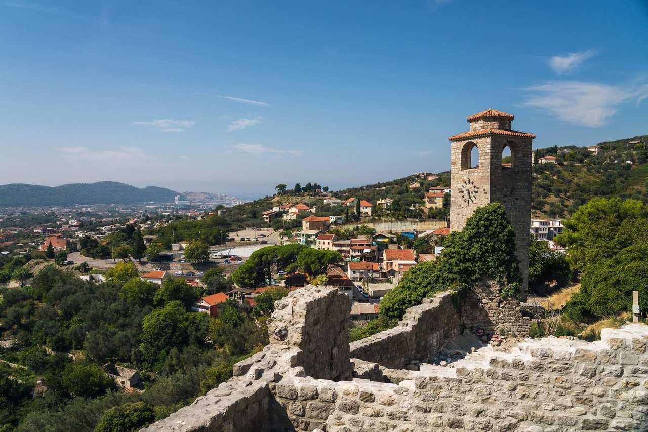 Stari Bar clock tower ruins and hills overlooking Bar, Montenegro, day, blue sky
