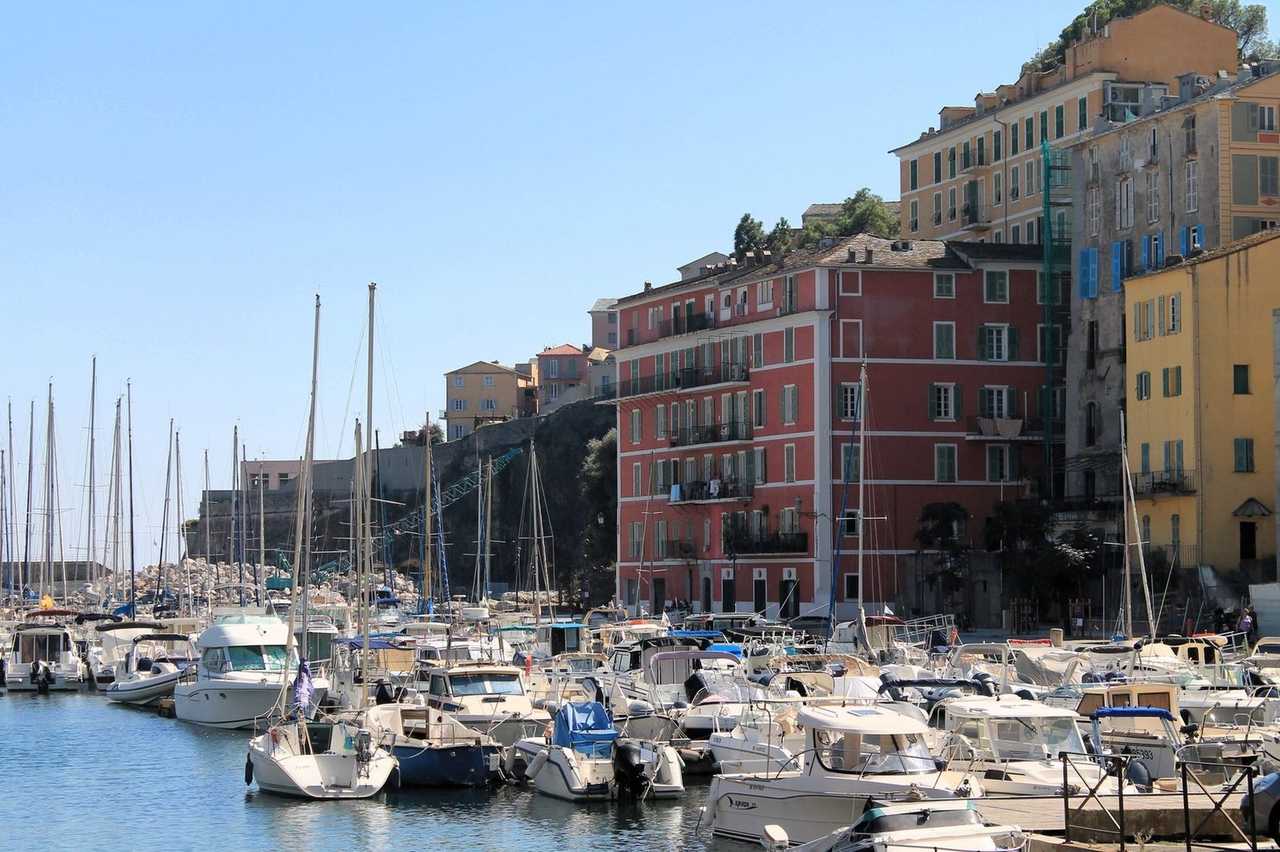 Bastia Vieux Port and colourful waterfront under solid blue sky
