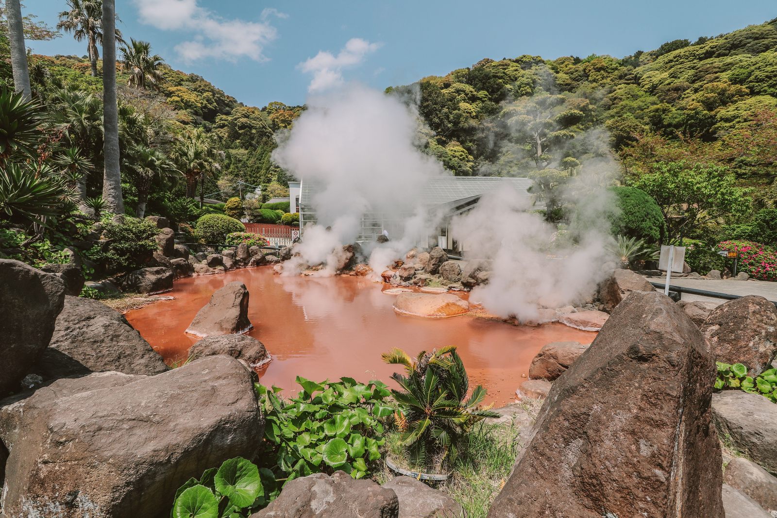 Steam rising over Beppu onsen town and bay