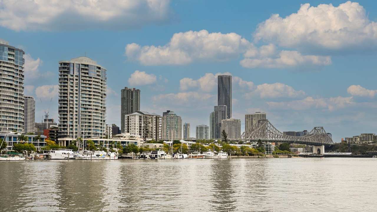 Brisbane skyline and Story Bridge across the Brisbane River, day, blue sky with cumulus