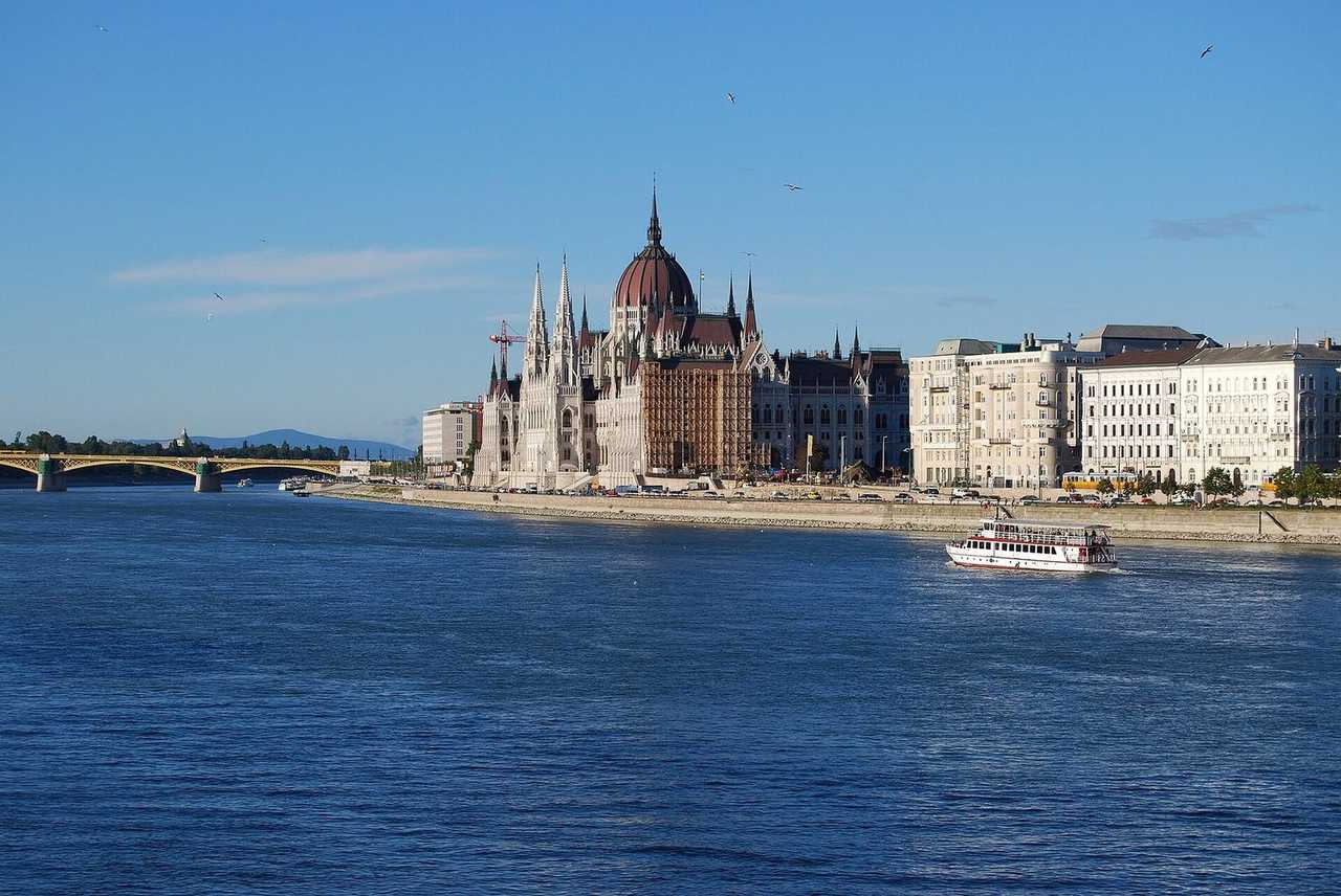 Hungarian Parliament on the Danube, day, blue sky