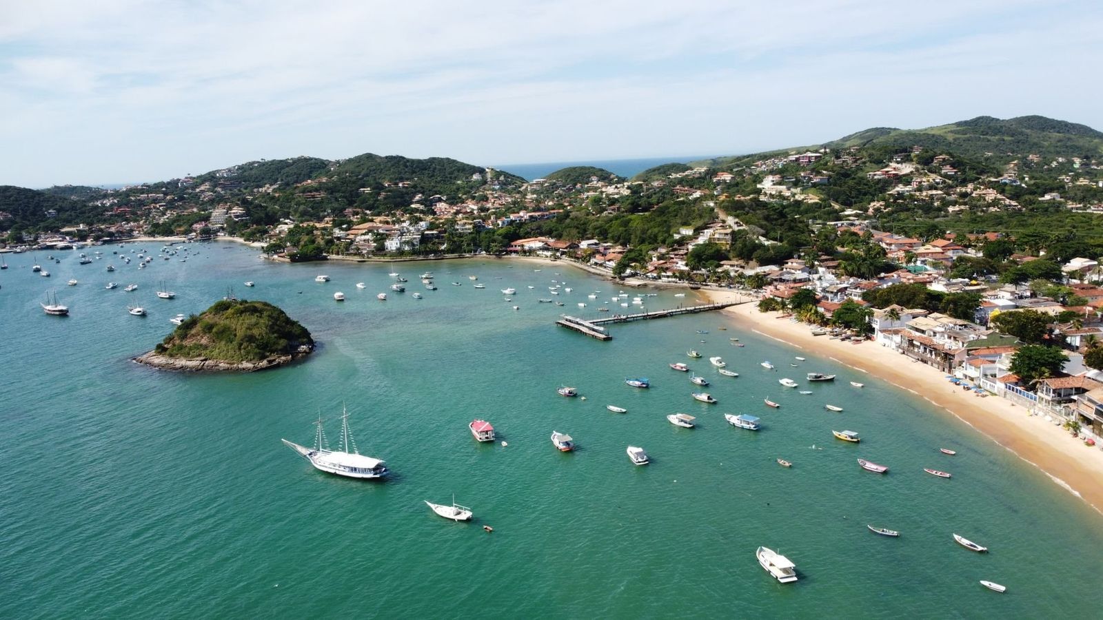 Búzios cove beach and peninsula hills above Atlantic water