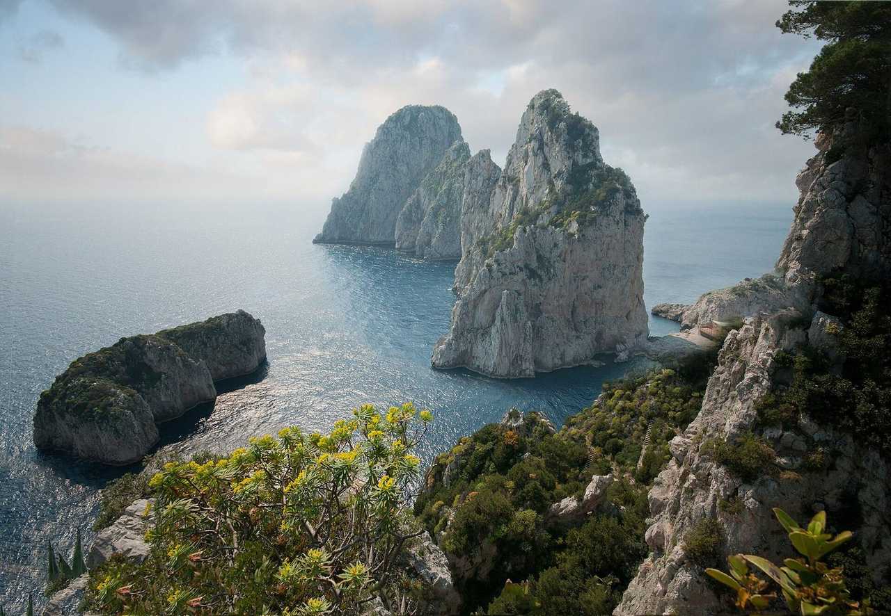 Faraglioni sea stacks, Capri, day, pale blue sky