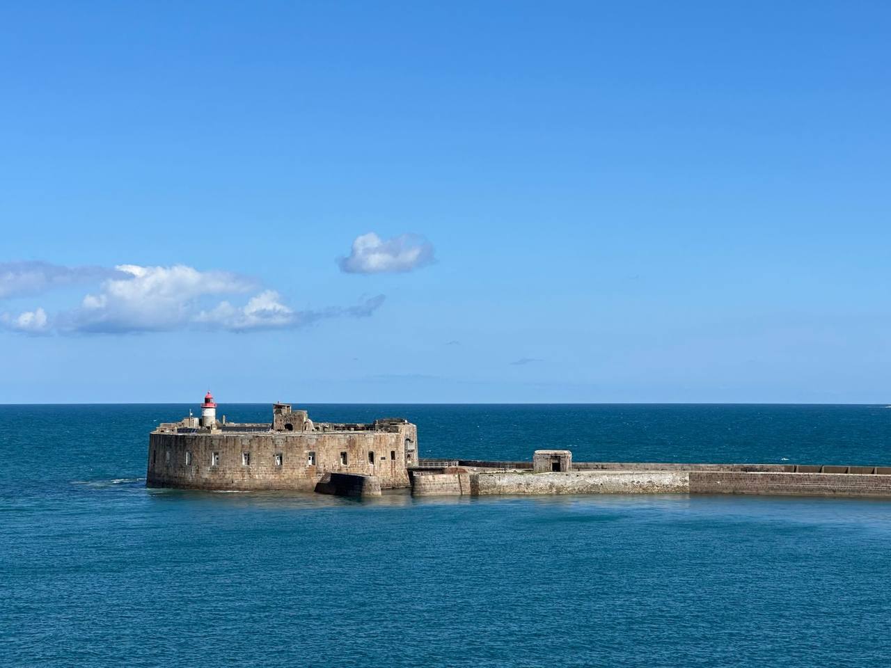 Fort de l'Île Pelée and lighthouse, Cherbourg, day, solid blue sky