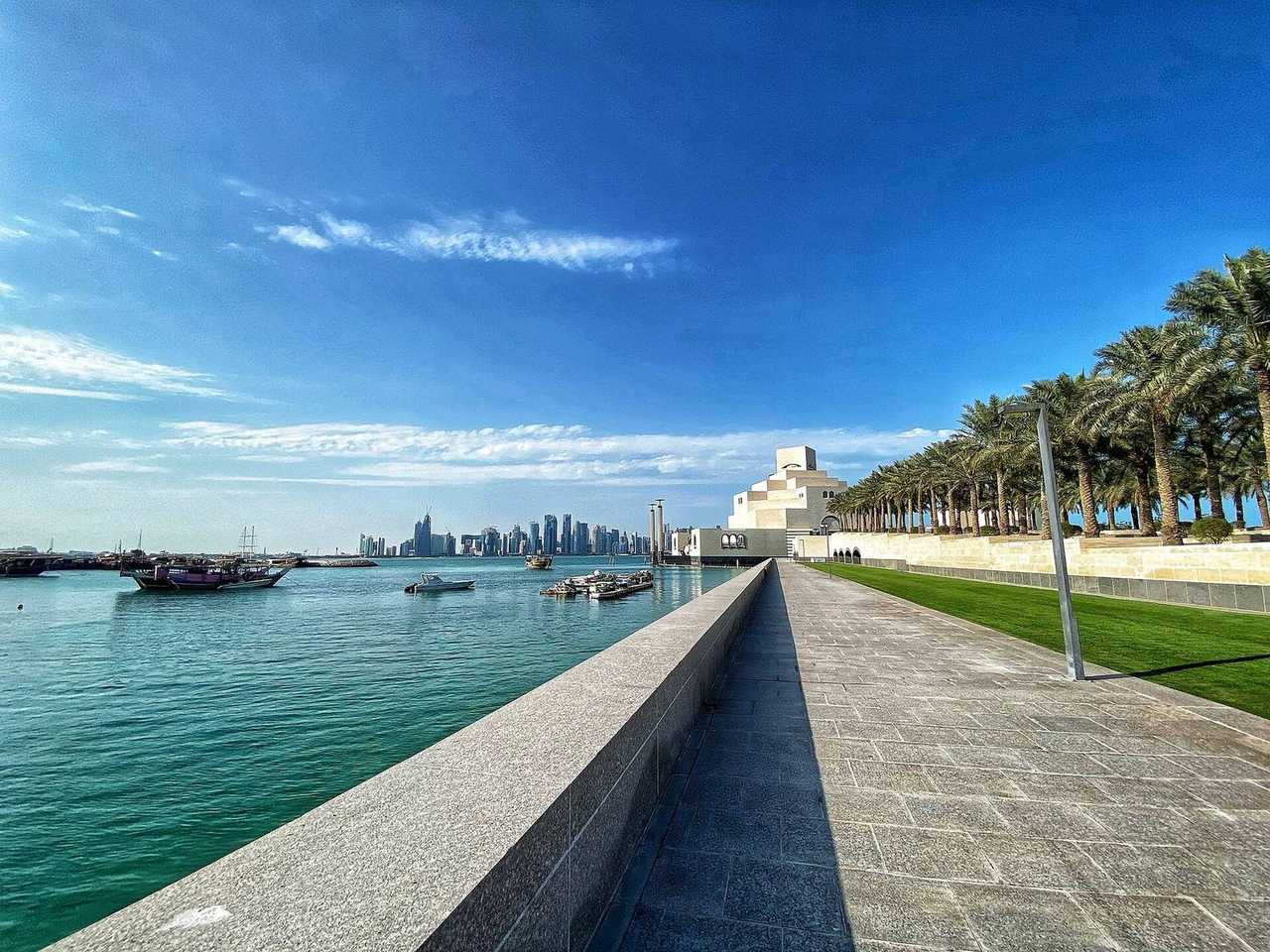 Museum of Islamic Art and West Bay skyline across Doha Bay, day, blue sky