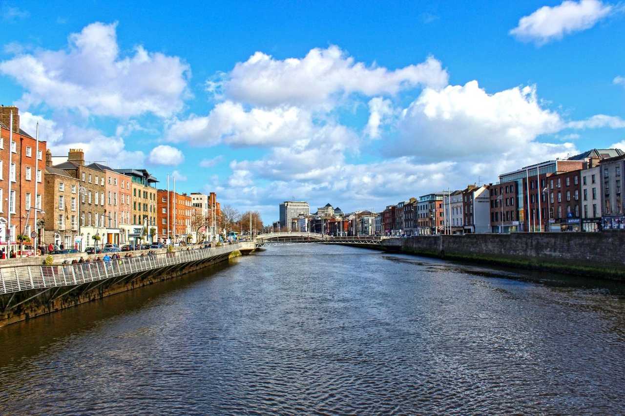 River Liffey toward Ha'penny Bridge, Dublin, day, blue sky with white clouds