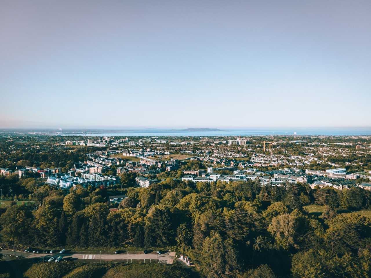 Dún Laoghaire / Dublin Bay elevated view toward Howth headland, day, pale blue sky