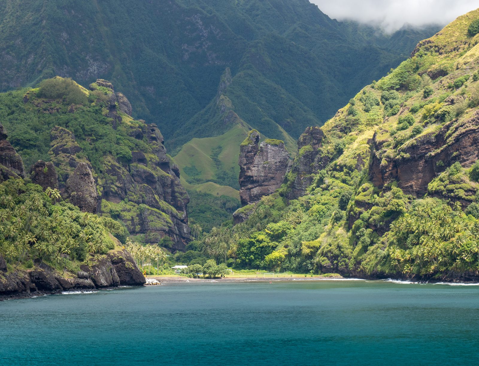 Basalt pinnacles and green cliffs at Hanavave Bay of Virgins Fatu Hiva