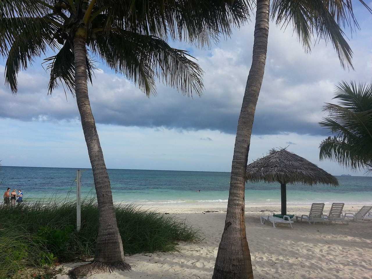 Taino Beach, Grand Bahama (Freeport), day, turquoise water with blue sky patches above cloud band