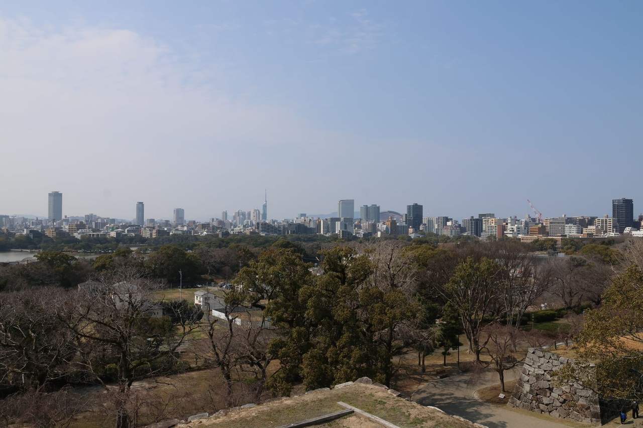 Fukuoka skyline from Fukuoka Castle / Maizuru Park stone wall, day, pale blue sky
