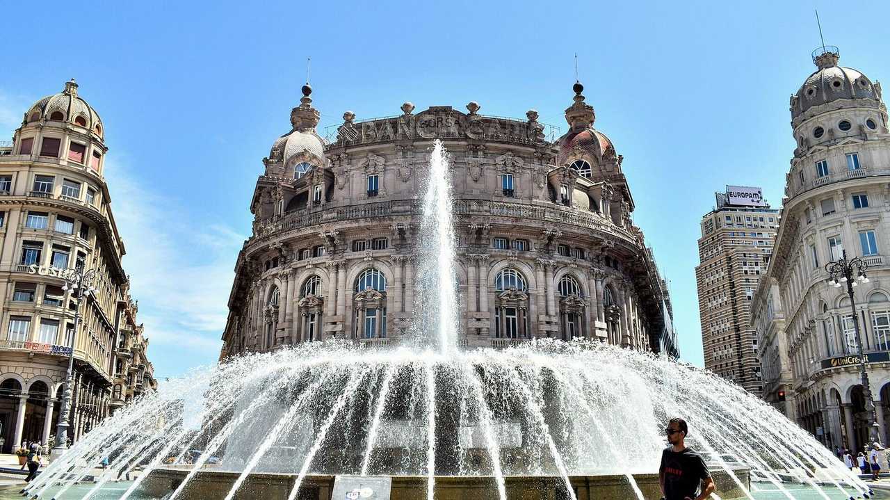 Piazza de Ferrari fountain and Palazzo della Nuova Borsa, day, blue sky