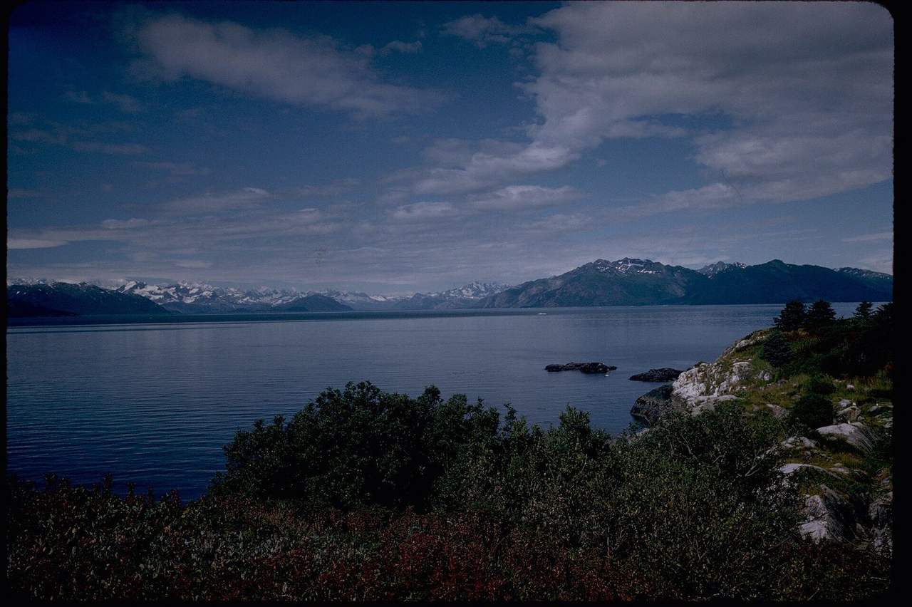 Glacier Bay mountains and water from the shore, day, blue sky