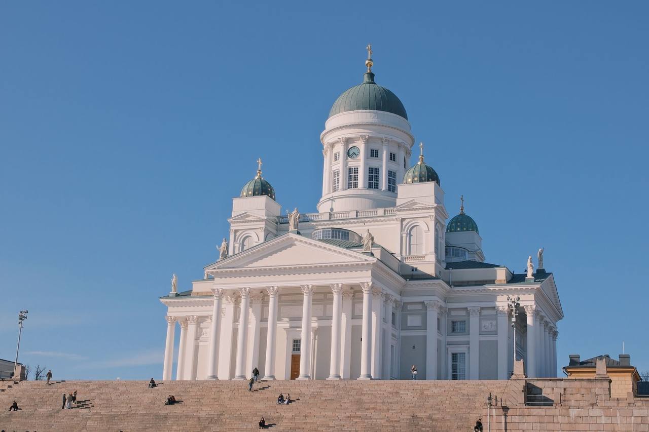Helsinki Cathedral green domes and Corinthian portico from Senate Square steps, day, clear blue sky