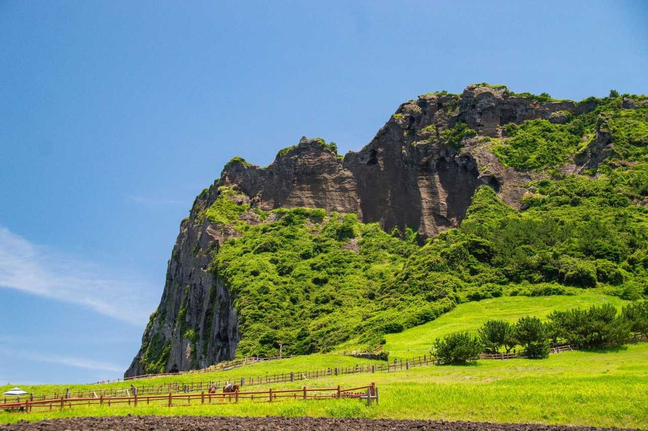 Seongsan Ilchulbong volcanic tuff cone, Jeju, day, solid blue sky