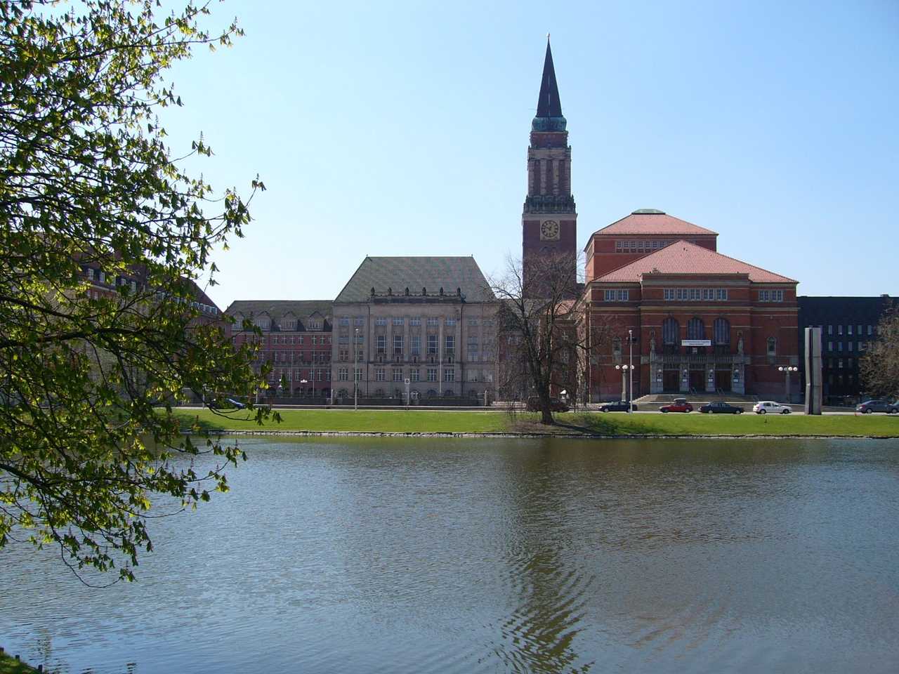 Kiel Rathaus tower and Opernhaus across Kleiner Kiel, day, clear blue sky