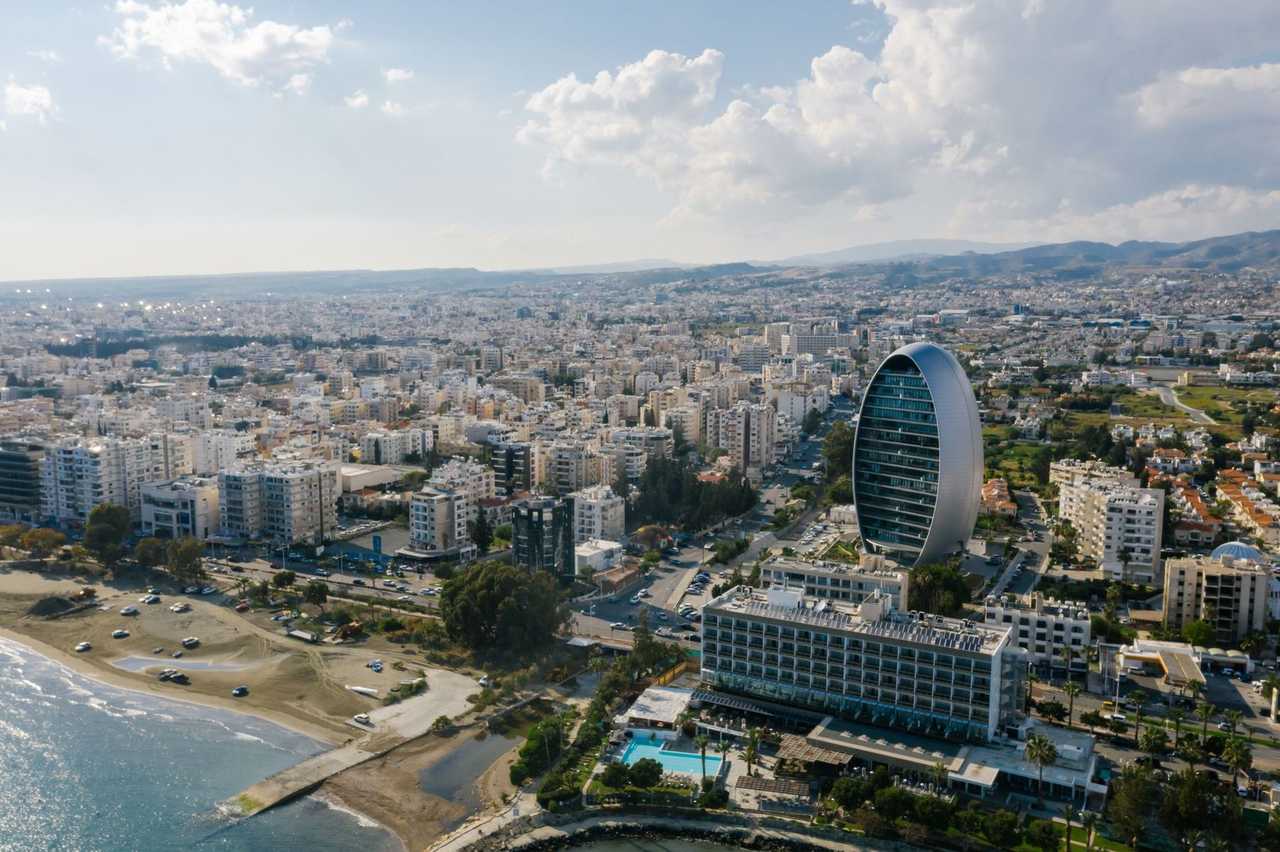 Limassol coastline aerial with The Oval tower landmark, day, blue sky with clouds