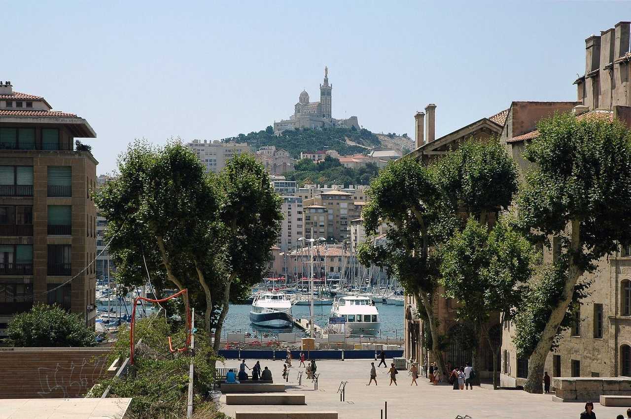Marseille Vieux-Port and Notre-Dame de la Garde from Place Villeneuve-Bargemon, day, pale blue sky