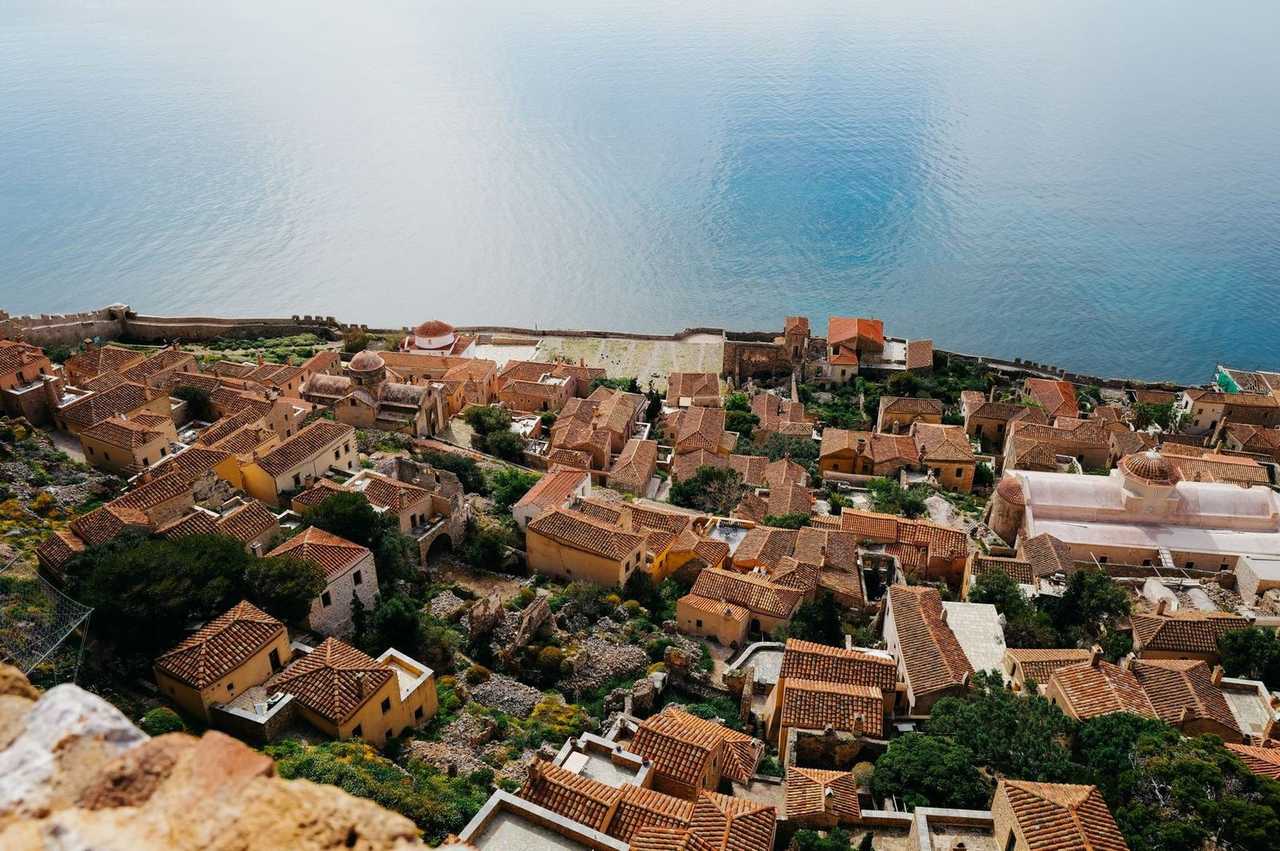 Monemvasia lower town rooftops and sea wall, day, bright daylight
