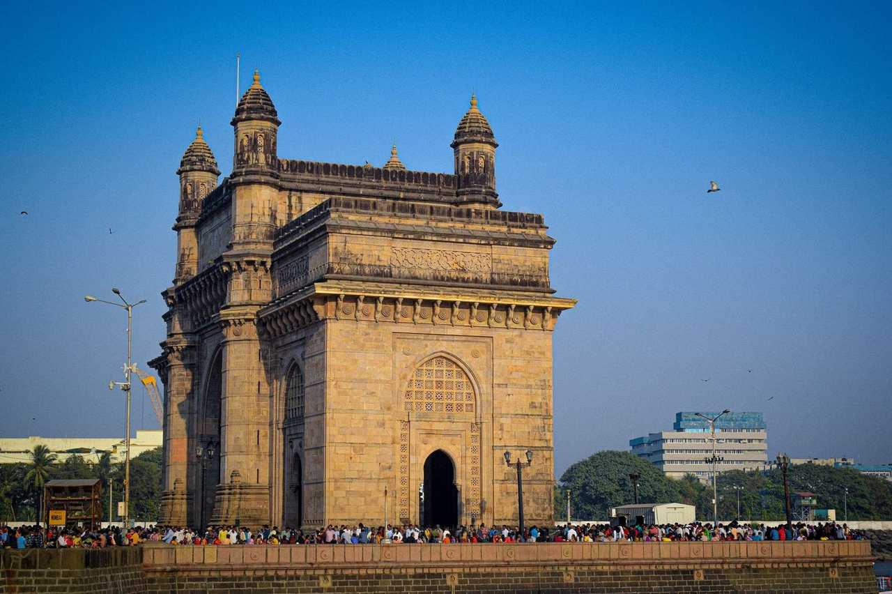 Gateway of India archway, Mumbai harbour edge, day, solid blue sky
