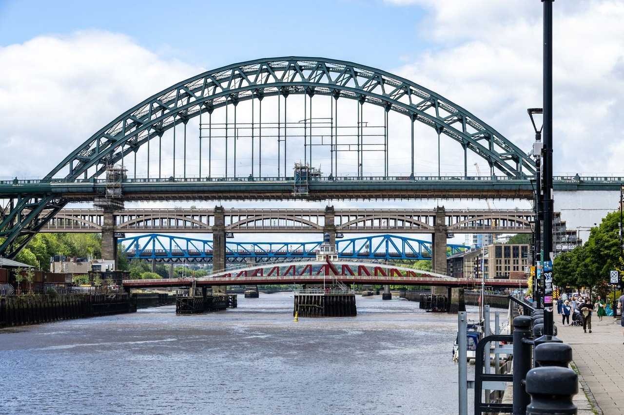Tyne Bridge and layered Tyne bridges, Newcastle, day, blue sky