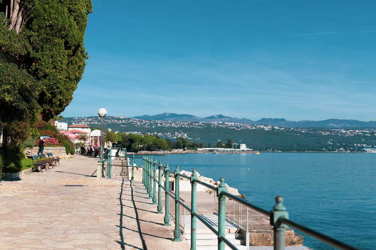 Opatija Lungomare promenade and Adriatic bay, day, solid blue sky
