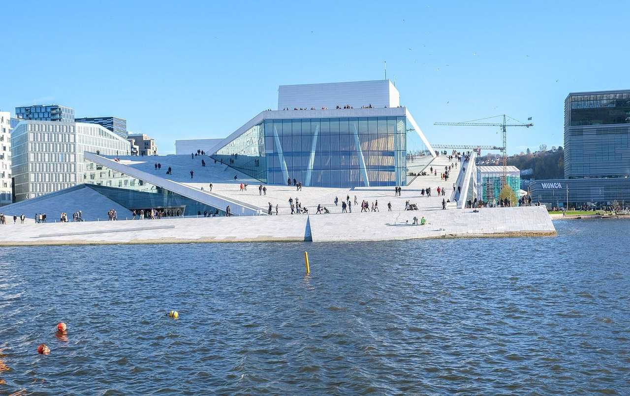 Oslo Opera House from the fjord, walkable marble roof, day, blue sky