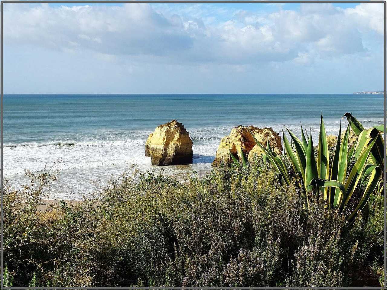Praia da Rocha limestone stacks and beach, Portimão Algarve, day, blue sky with clouds