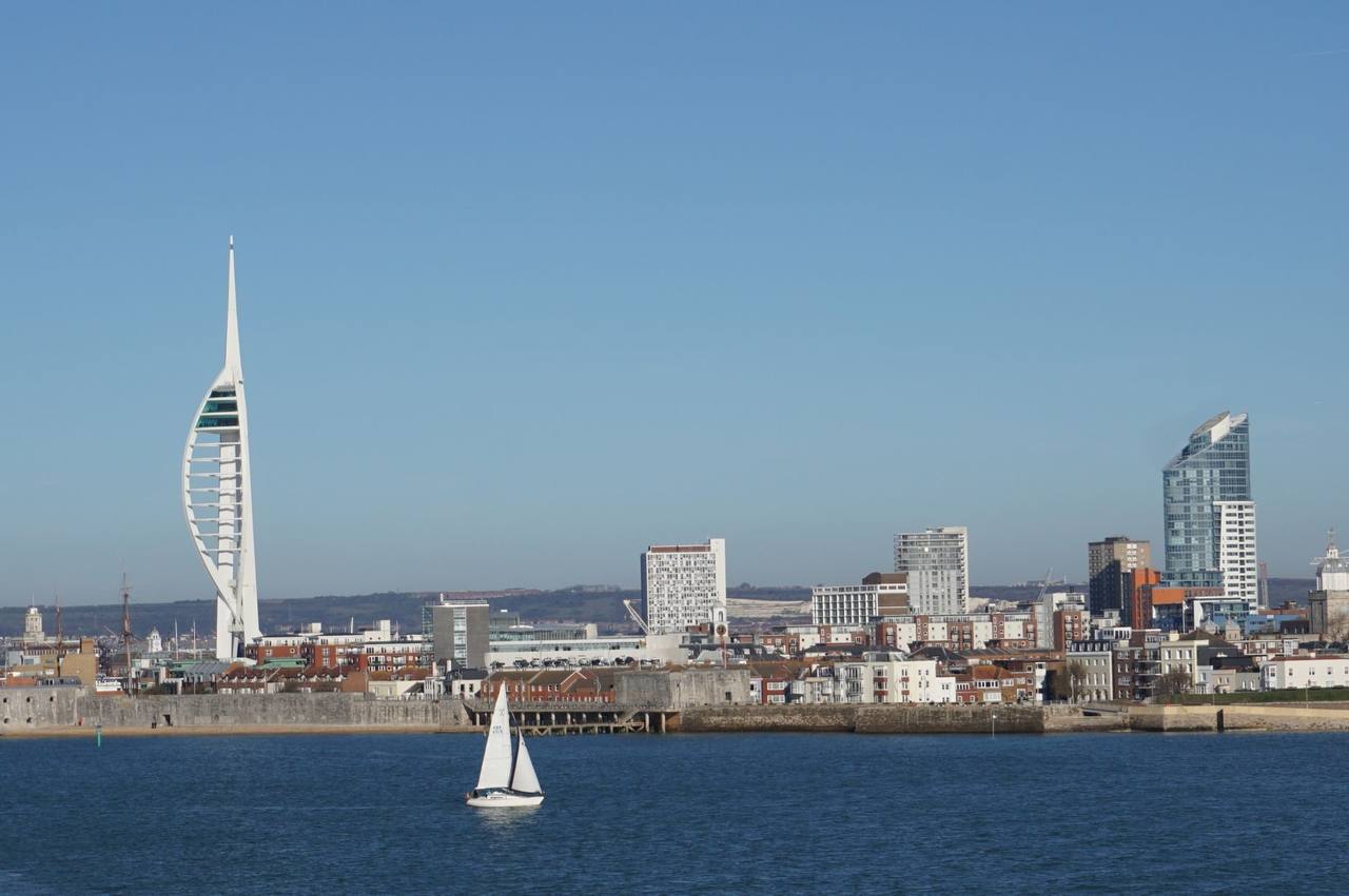 Spinnaker Tower and Portsmouth skyline from the water, day, solid blue sky