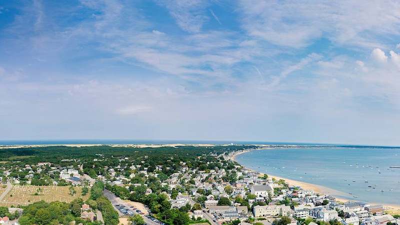 Provincetown harbour and Pilgrim Monument above Commercial Street