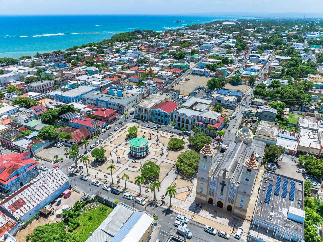 Puerto Plata Parque Central and Catedral San Felipe, day, blue sky; coast behind