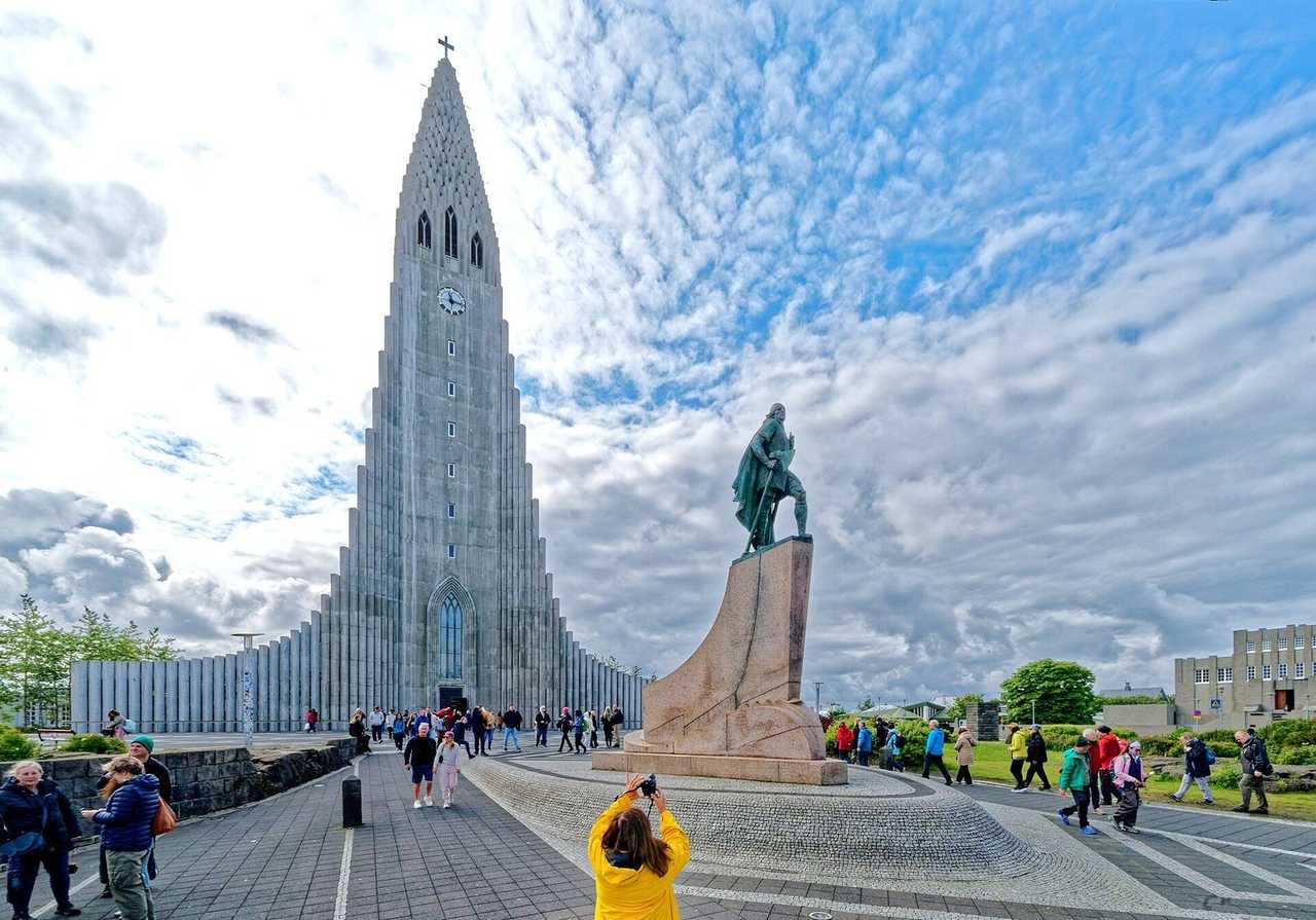 Hallgrímskirkja and Leif Erikson statue from the plaza, day, blue sky with clouds