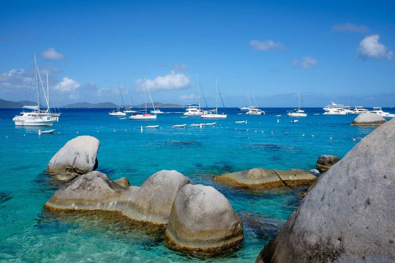 The Baths boulder bay with catamarans, BVI (Tortola call), day, solid blue sky