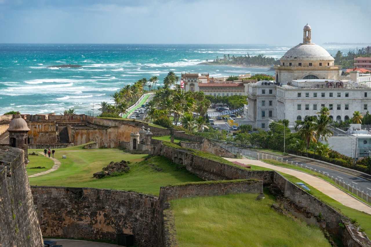 San Juan fortifications with El Capitolio and Atlantic, day, light blue sky