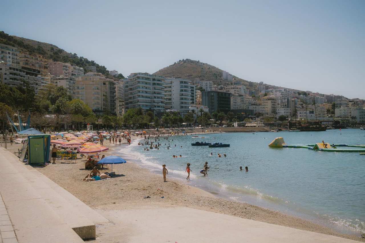 Sarandë beach and hillside apartments, day, clear blue sky