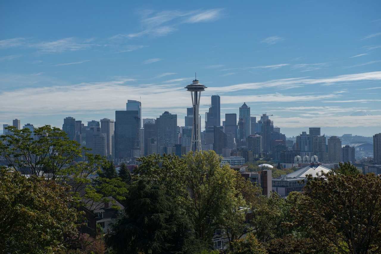 Seattle Space Needle with downtown skyline and Mount Rainier, day, blue sky