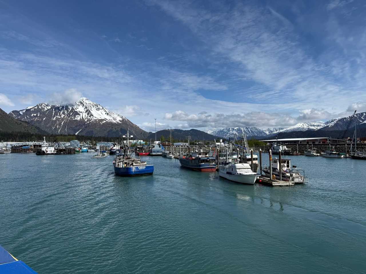 Seward AK harbour with snow mountains; SEWARD AK on fishing boat stern, day, blue sky