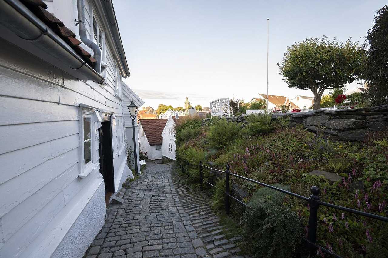 Gamle Stavanger white wooden houses, day, pale blue sky