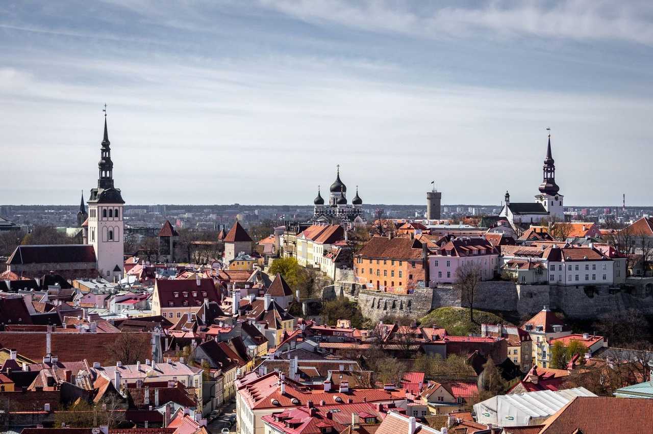 Tallinn Old Town red roofs, Alexander Nevsky and church spires, day, pale blue sky