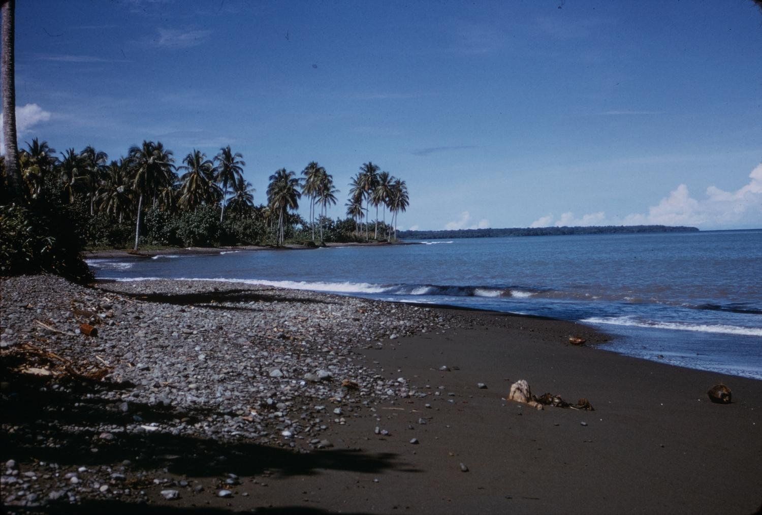 Palm-lined village shore on Papua New Guinea’s Trobriand coast