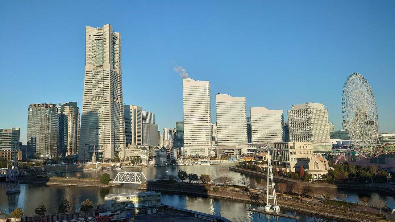 Yokohama Minato Mirai 21 skyline with Landmark Tower and Cosmo Clock 21, day, solid blue sky