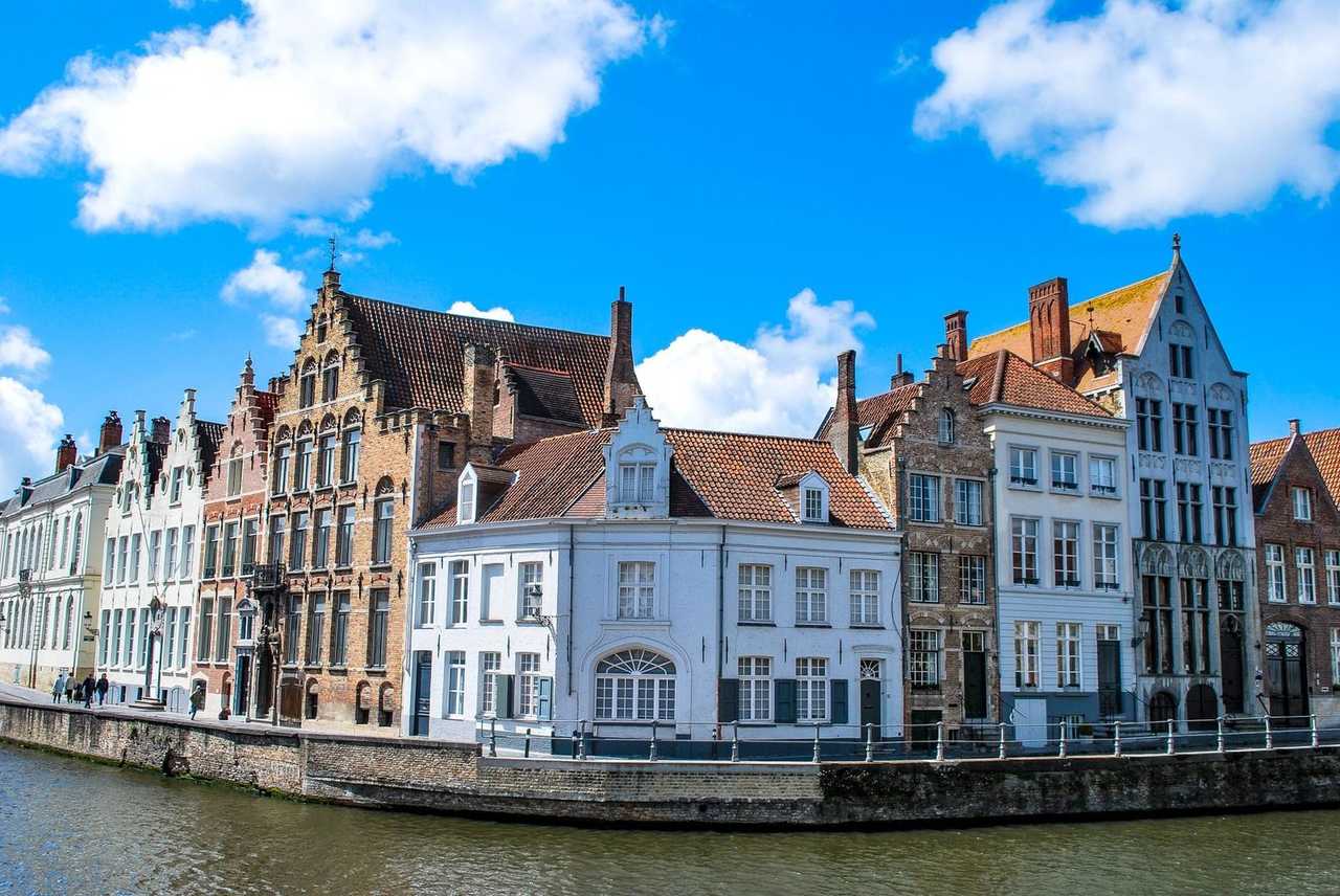 Bruges canal townhouses (Zeebrugge call), day, vibrant blue sky