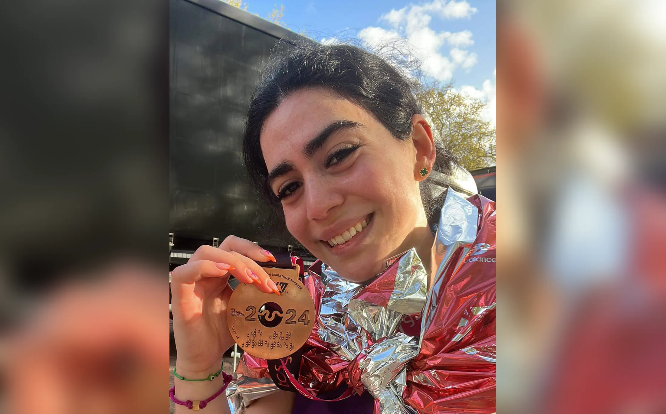 Kate smiling and holding her London Marathon 2024 completion medal
