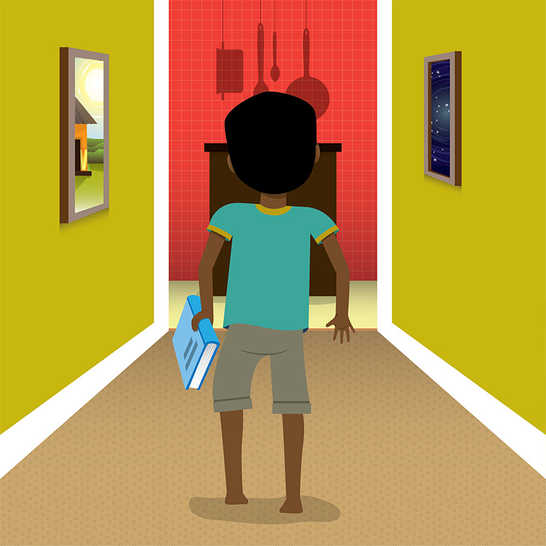 A boy holding a book walking in a hallway.